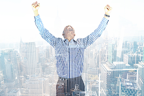 Composite image of excited businessman cheering
