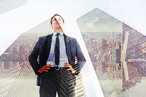 Composite image of happy businessman with hands on hips