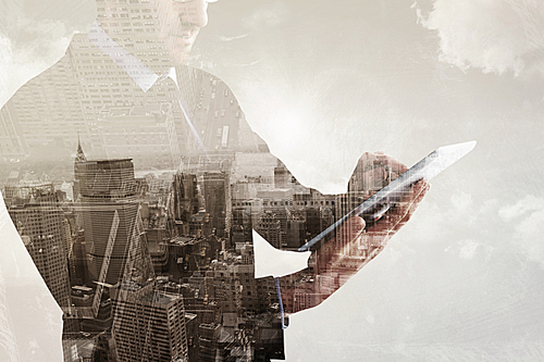 Composite image of mid section of a businessman using digital tablet