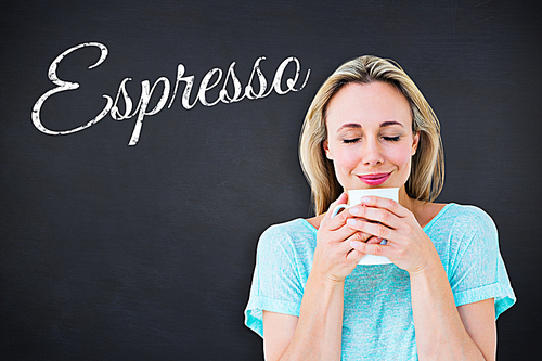 Composite image of cheerful blonde holding mug of hot drinking