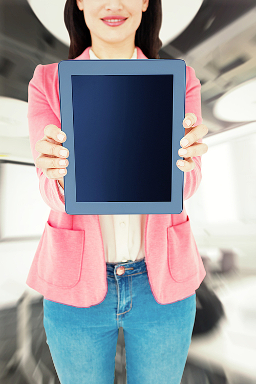 Composite image of elegant brunette using tablet