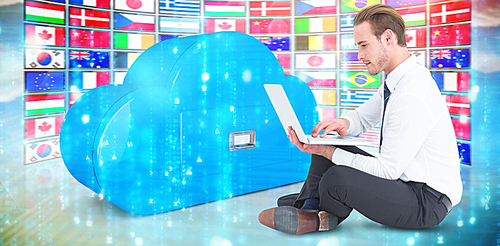 Composite image of smiling businessman sitting on floor using laptop