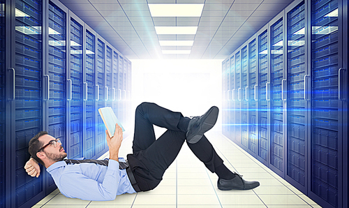 Composite image of businessman lying on the floor while reading a book