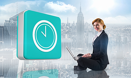 Composite image of redhead businesswoman using her laptop