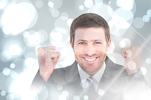 Composite image of businessman smiling and cheering