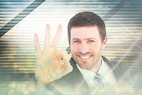 Composite image of businessman smiling and making ok sign