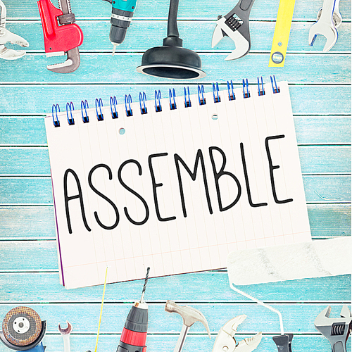 Assemble against tools and notepad on wooden background