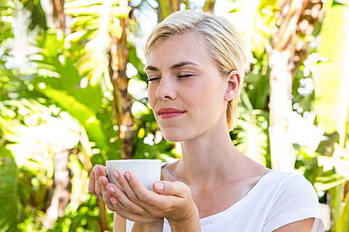 Attractive blonde woman holding mug