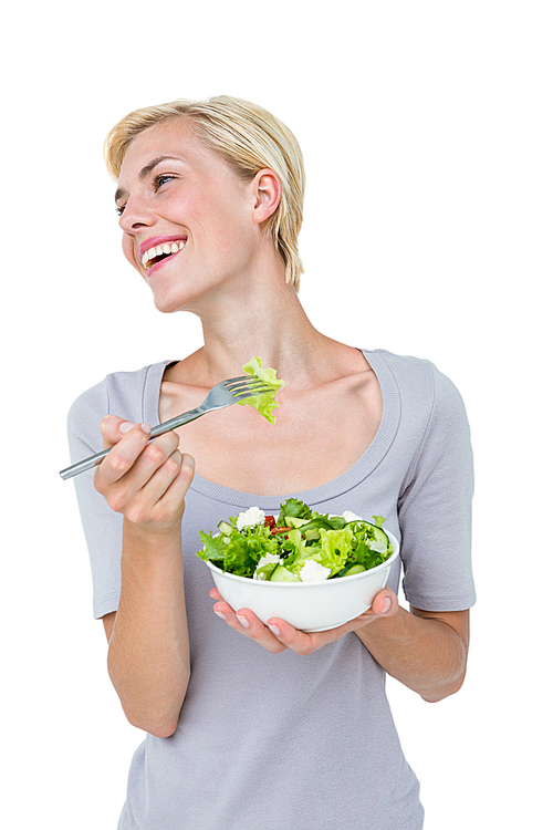Happy blonde woman holding bowl of salad