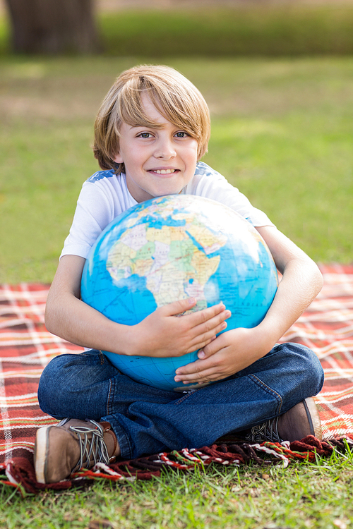 Little boy holding a globe