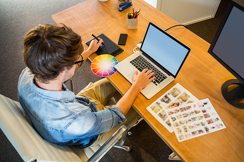 Designer working with colour wheel and digitizer