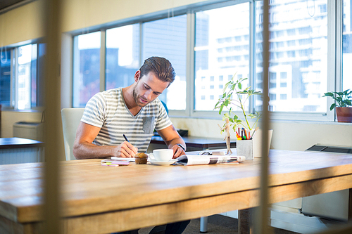 Casual businessman working at his desk