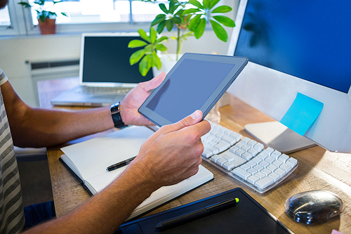 Casual businessman working on tablet