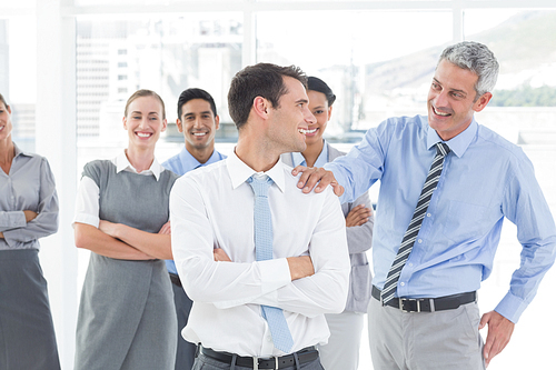 Businessman congratulating his colleagues in office