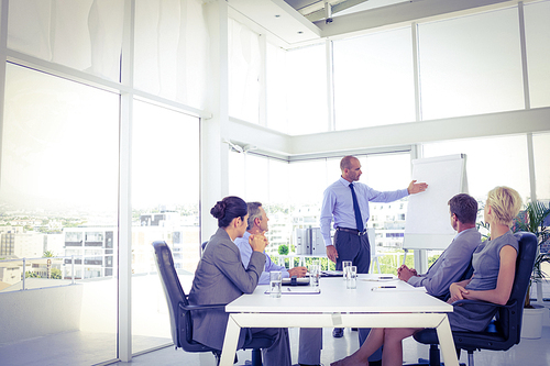 Businessman giving presentation to his colleagues in the office