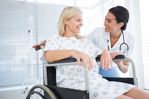 happy doctor smiling at her patient in . in hospital