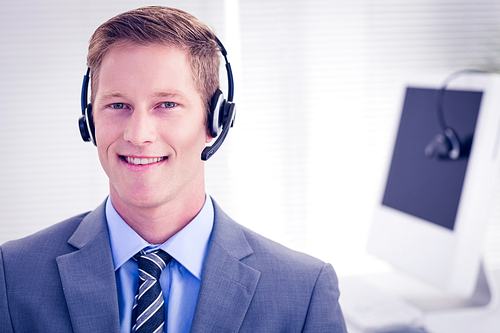 Handsome agent wearing headset in call center