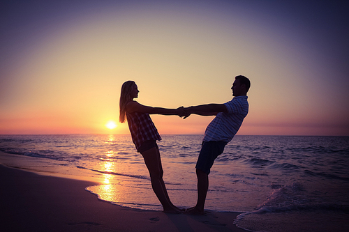 Romantic couple at sunset on the beach