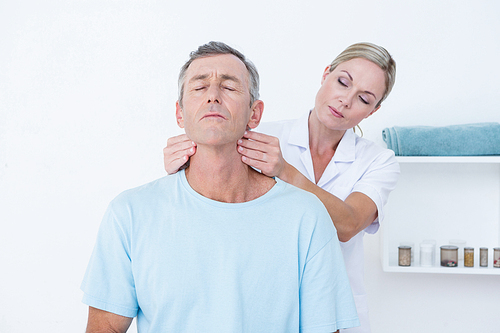 Doctor doing neck adjustment in medical office