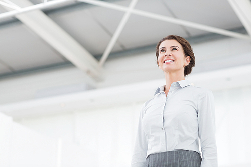 Thoughtful businesswoman looking away in her office