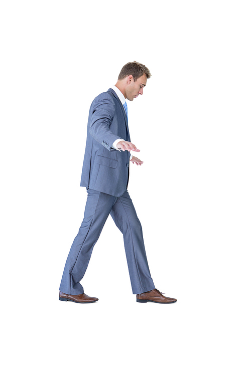 Businessman walking in equilibrium on white background