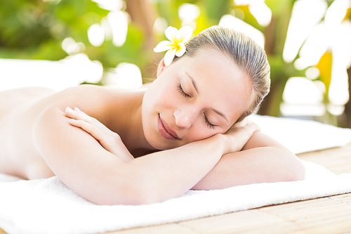 Peaceful blonde lying on towel at the health spa