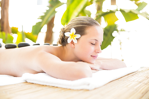Peaceful blonde lying on towel at the health spa