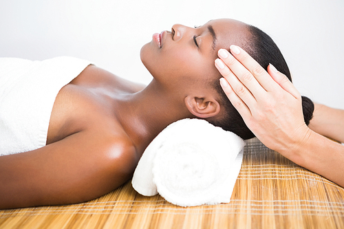 Pretty woman enjoying a head massage at the health spa