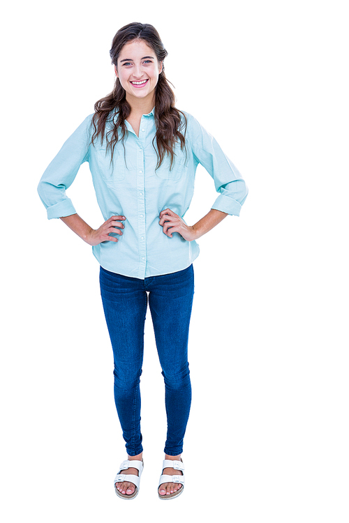 Pretty hipster with hands on hips smiling at camera on white background