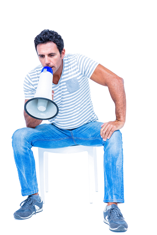 Sitting man shouting through megaphone on white background