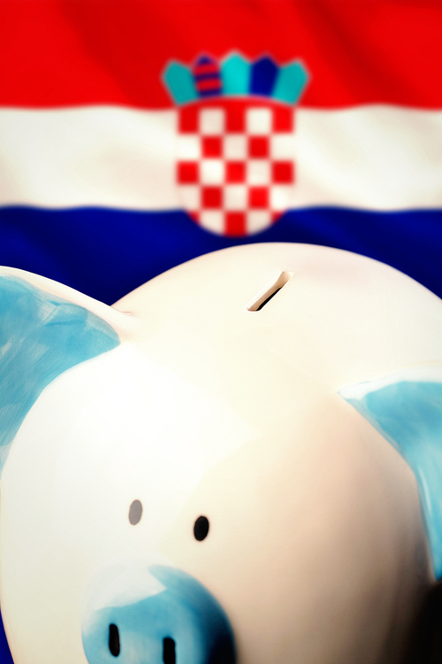 Piggy bank against digitally generated croatia national flag