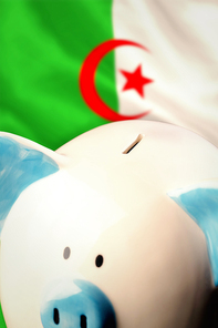 Piggy bank against algerian flag