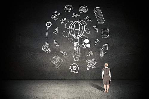 Back turned businesswoman holding a briefcase against black wall