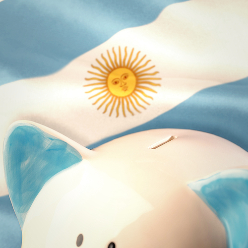 Piggy bank against argentinian flag