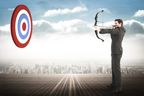 Businessman shooting a bow and arrow against city on the horizon
