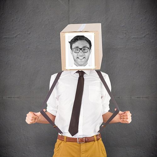 Businessman with photo box on head against grey concrete tile