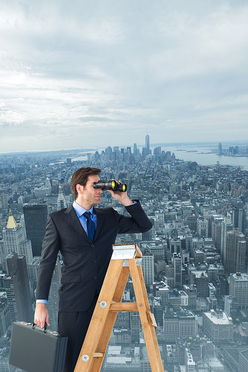 Businessman looking on a ladder against new york