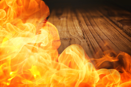 Fire against wooden desk