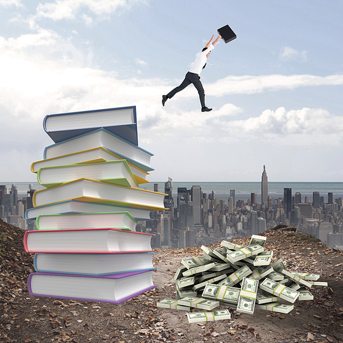 Businessman leaping with his briefcase against stack of books