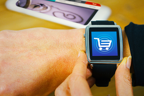 Businesswoman with smart watch on wrist against trolley