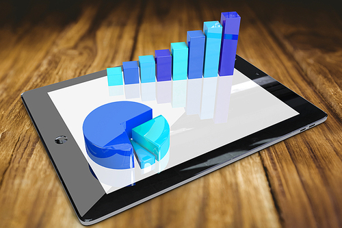 Tablet pc with graphs against wooden table