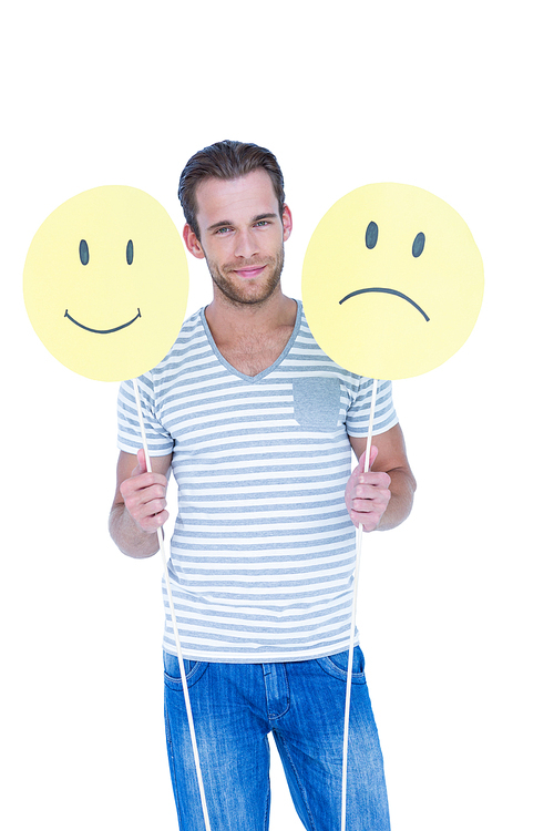 Handsome man holding smiley faces on white background