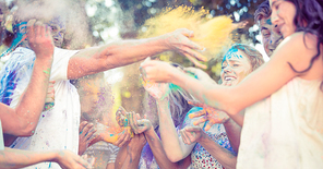 Friends having fun with powder paint on a sunny day