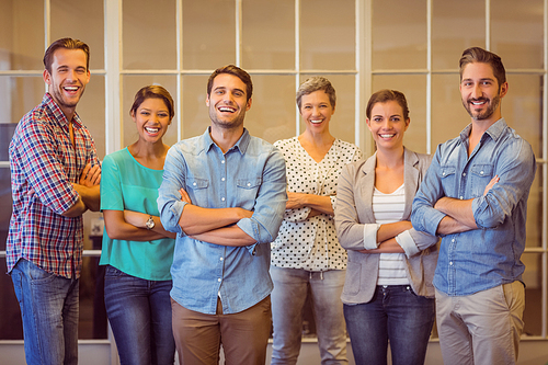 Group portrait of a smiling creative business team looking at the camera