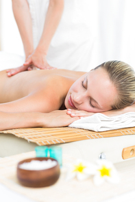 Pretty blonde enjoying a massage at the health spa