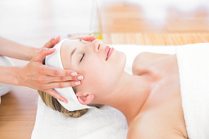 Pretty blonde enjoying a massage at the health spa