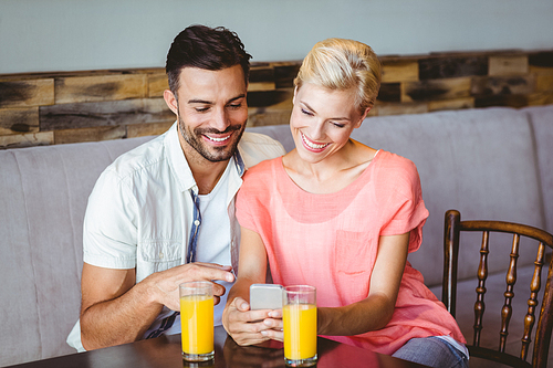 Couple taking a glass of juice at the cafe