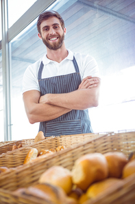 Smiling worker posing behind the counter at the bakery