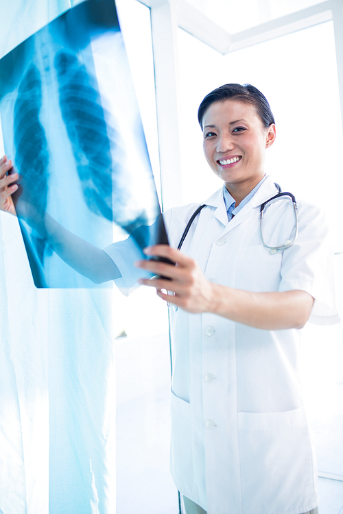 Female doctor examining x-ray in the medical office