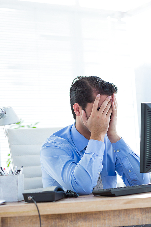 Serious businessman sitting on chair in his office